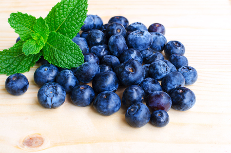 Fresh blueberries with mint on wooden  backgroundの写真素材