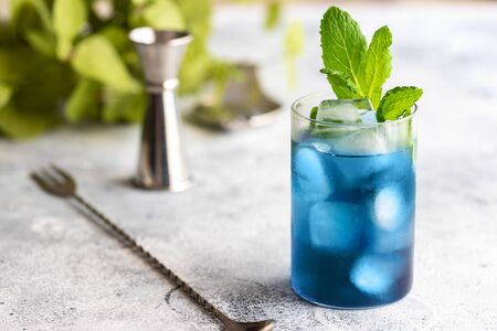 Blue lagoon, Tropical cocktail served with ice cubes decorated with mint. Refreshing alcohol drink for party at summer.の写真素材