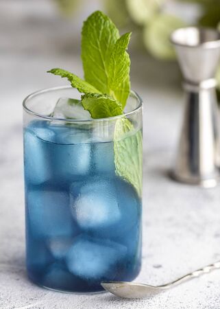 Blue lagoon, Tropical cocktail served with ice cubes decorated with mint. Refreshing alcohol drink for party at summer.の写真素材