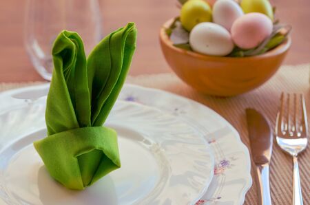 Spring dinner party decoration en green tone. Beautiful Easter table settings, cute bunny shaped...