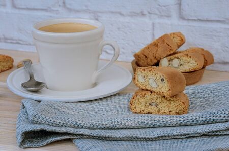 Homemade biscotti cantuccini, Italian almond sweets biscuits with  cup of coffee  on woodem table. Fresh Italian cookies cantucci background. の写真素材