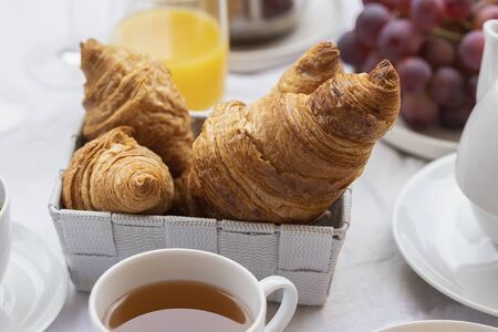 French breakfast, hot beverage and croissants, fruits, orange juice. Good morning concept...