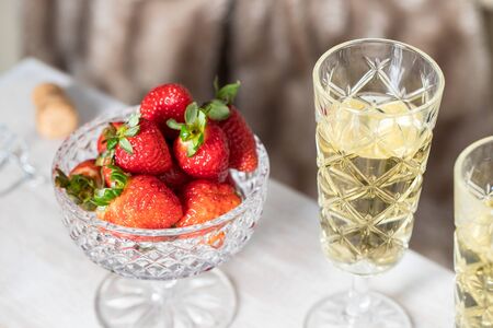 Romantic date concept. Two Champagne glasses and strawberry   on wooden table. for Saint Valentines day celebration.の写真素材