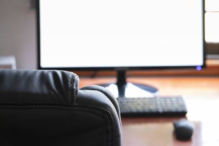 Leather chair and display computer at home office. Work at distance concept.