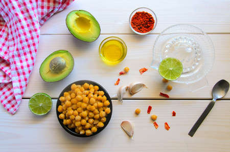 Ingredients for cooking delicious Avocado hummus. Chickpeas, olive oil, lemon juice, garlic and...