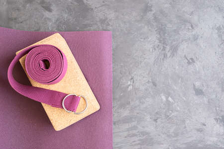 Open yoga mat with cork block and yoga belt. Yoga practice props background. Copy space.の写真素材