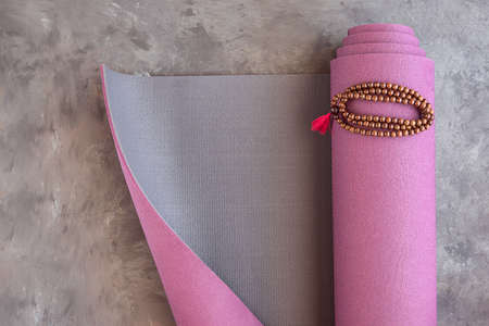 Yoga mat and classic mala beads, essential things for yoga practice and meditation.Copy spaceの写真素材