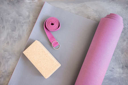 Open yoga mat with cork block and yoga belt. Yoga practice props background. Copy space.の写真素材