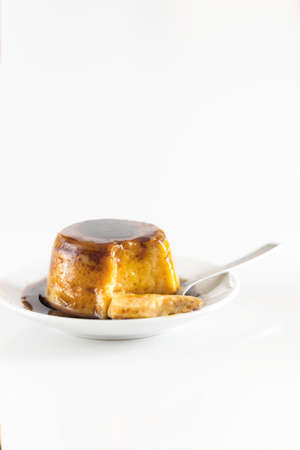 Creme caramel dessert or flan on white table. Popular egg sweet background.
