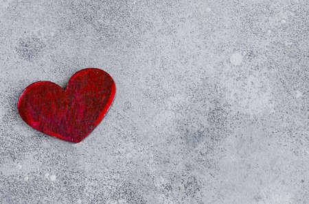 Red heart symbol of love on winter background with copy space. Concept for Saint Valentine Day celebration.の写真素材