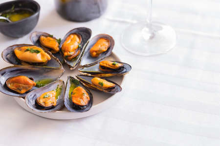 Steamed black mussels cooking in sauce and served with wine. Popular Mediterranean seafood dish...