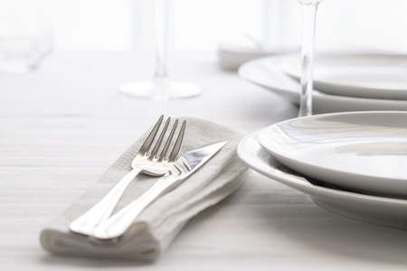 Table set with silver cutlery and glassware. Dining concept background. Close up.の写真素材