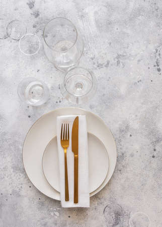 Gold cutlery knife and fork , wine glasses on the stone background for restaurant dinner concept.の写真素材