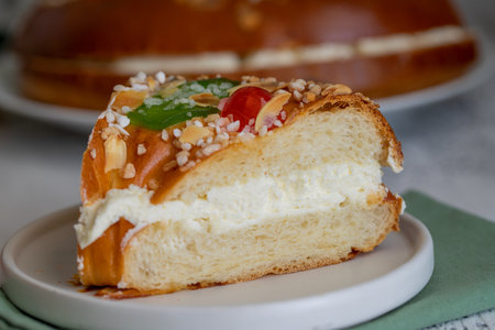 Piece of Roscon de reyes, spanish Christmas cake to celebrate Epiphany or Dia de Reyes Magos, Three...