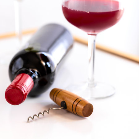 Red wine bottle with wine glass on white background. Wine lovers concept.の写真素材