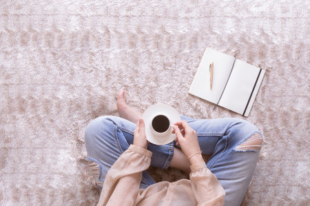 Woman holding notebook to write notes for her blog. Blogging lifestyle and working at home concept. copy-spaceの写真素材