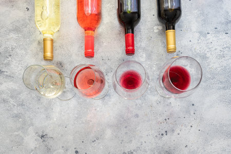 Bottles of different wines red, white, rose and Bordeaux with wine glases. Wine Collection Flat lay background.の写真素材