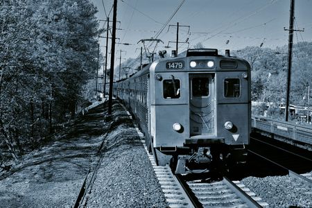 train on the tracks in black and white