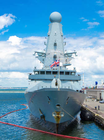 A warship, destroyer Defender in the port of Odessa at the pier on a sunny June day