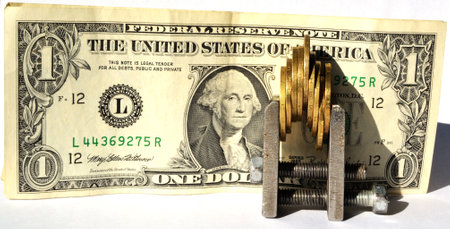 Dollar and clamp with coins on a white background