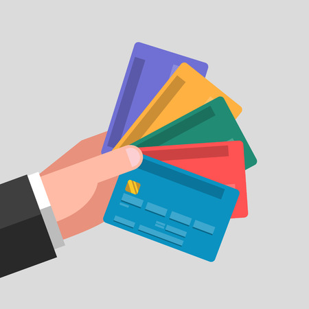 Various colored bank cards in one hand. Different cards for different casesのイラスト素材