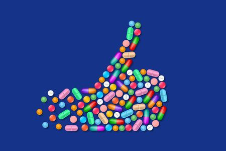 Thumb up gesture made from many various colorful tablets, pills and medicines. Concept of successful...