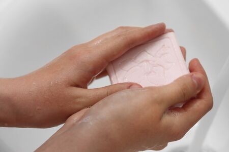 A woman washes her hands with soap. Hygiene concept. Soaping. Lathering handsの写真素材