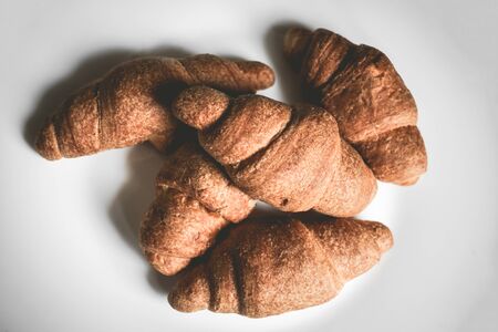Croissants on a white plate. Fresh bakery