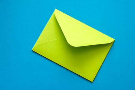 Green Envelope on a Blue Background. Postal envelope. Love letter. Colorful photo of the postal...