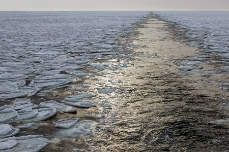 Ships sailing on the North Sea in the ice and leaves a wakeの写真素材