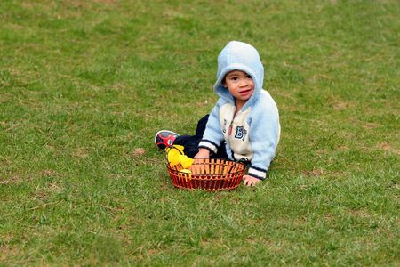 small boy sitting on the meadow