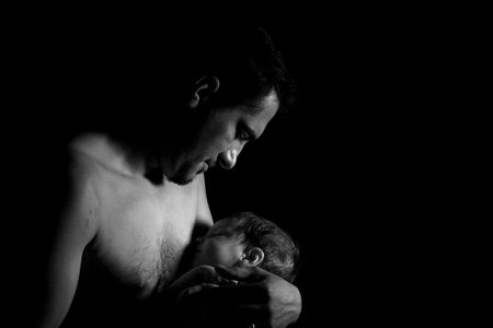 young father holding his daughter in the handsの写真素材