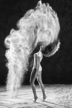 Black and white portrait of young dancer with white flour flipping from her hairの写真素材