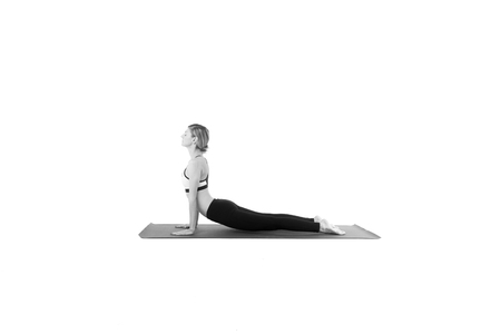 Sporty young woman doing yoga practice isolated on white backgroundの写真素材