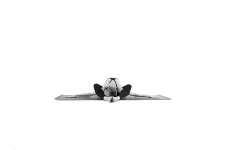 Sporty young woman doing yoga practice isolated on white backgroundの写真素材
