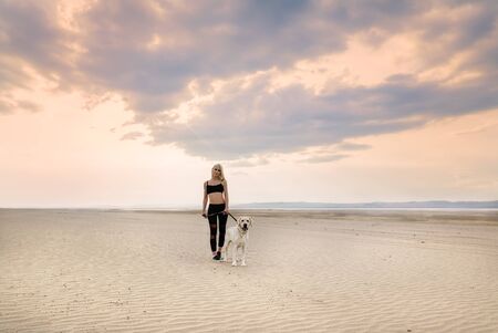 Girl with dog on beach