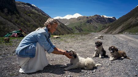Girl petting happy puppies alabais summerの写真素材