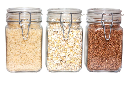 Three glass jars of rice and buckwheat and oat flakesの写真素材