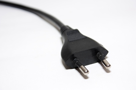 Black electric plug on white background