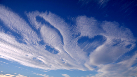 Cirrus clouds in the sky in the form of a heart. Unusual, romantic cloudsの写真素材