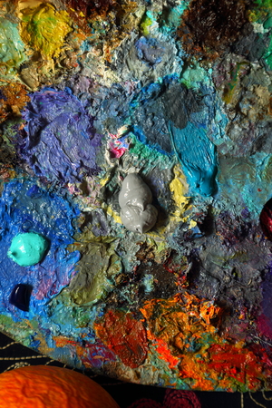 this is a fragment of a palette with oil paints while painting a painting.の写真素材