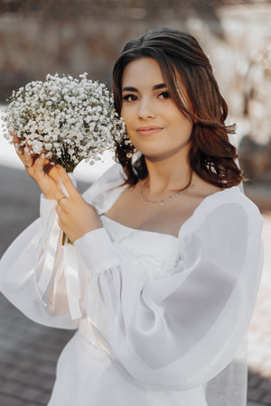 Portrait of a beautiful bride with a bouquet of flowers.の写真素材
