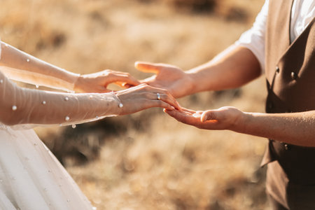 A beautiful luxury wedding. Close-up of bride and groom's hands. The groom holds the bride's hand....