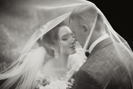 Groom and bride in the park. Autumn wedding in the forest. Happy wedding, loving couple tender...