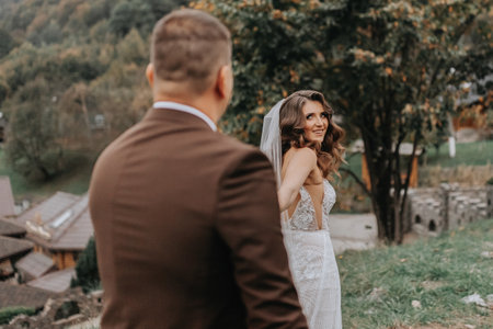 The bride in a wedding dress leads the groom on a wedding journeyの写真素材