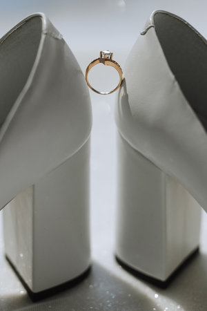 Close up of a gold ring with a diamond. Love, relationship and wedding concept. Soft and selective focus. Free spaceの写真素材