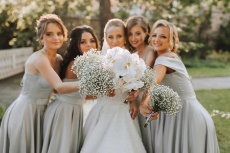 Group of beautiful girls with bride in matching dresses smiling, celebrating and having fun together. Girls partyの写真素材