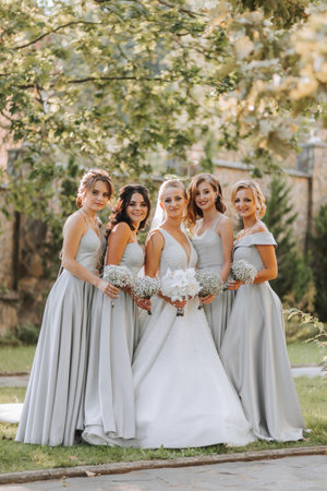 Group of beautiful girls with bride in matching dresses smiling, celebrating and having fun together. Girls partyの写真素材