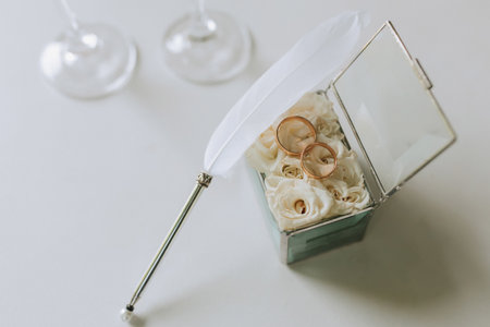 wedding rings on a white table and preparation for the wedding ceremony. White pen for signaturesの写真素材