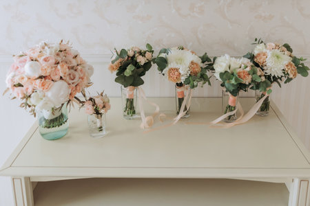 the bride with a French manicure holds a white garter in her hands. Close-up photoの写真素材